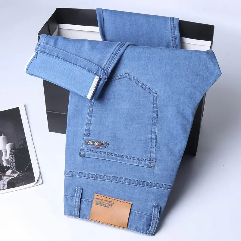 Nuevos pantalones vaqueros finos de seda de hielo para hombres, pantalones de algodón elásticos rectos azules, pantalones ligeros informales de negocios para primavera y verano