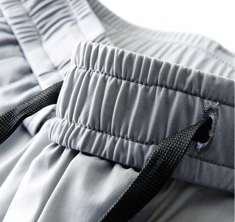 Pantalones informales finos de tela de seda de hielo suave para hombre, pantalón recto de estilo coreano, de alta elasticidad, marca de lujo, verano 2024