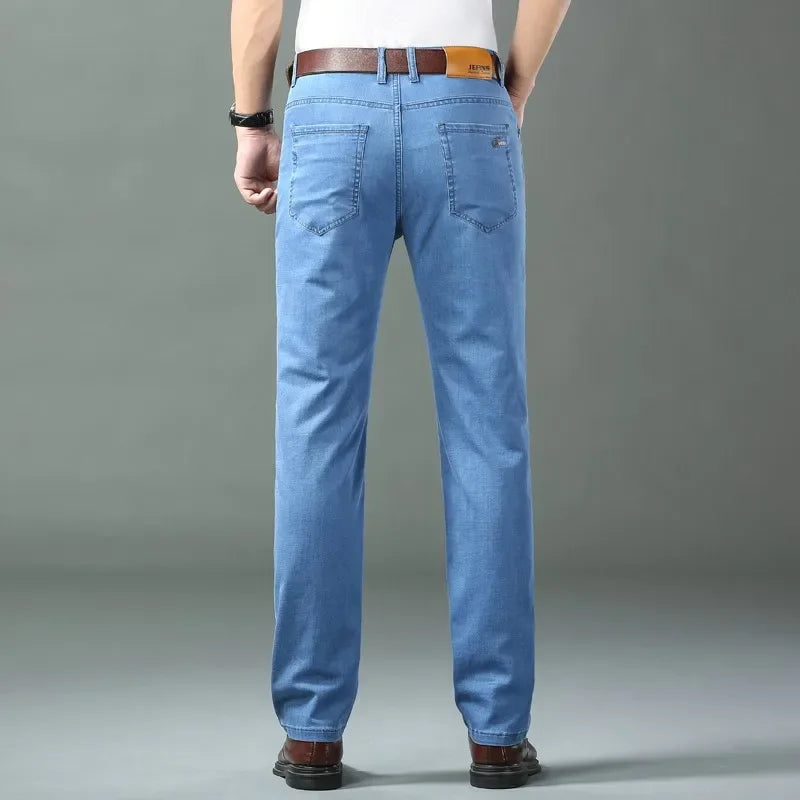 Nuevos pantalones vaqueros finos de seda de hielo para hombres, pantalones de algodÃ³n elÃ¡sticos rectos azules, pantalones ligeros informales de negocios para primavera y verano